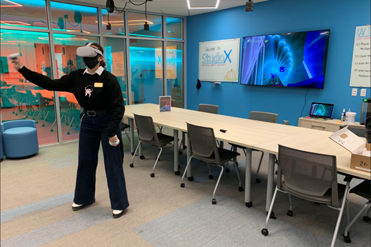 Ayiana Crabtree playing Beat Saber in virtual reality.