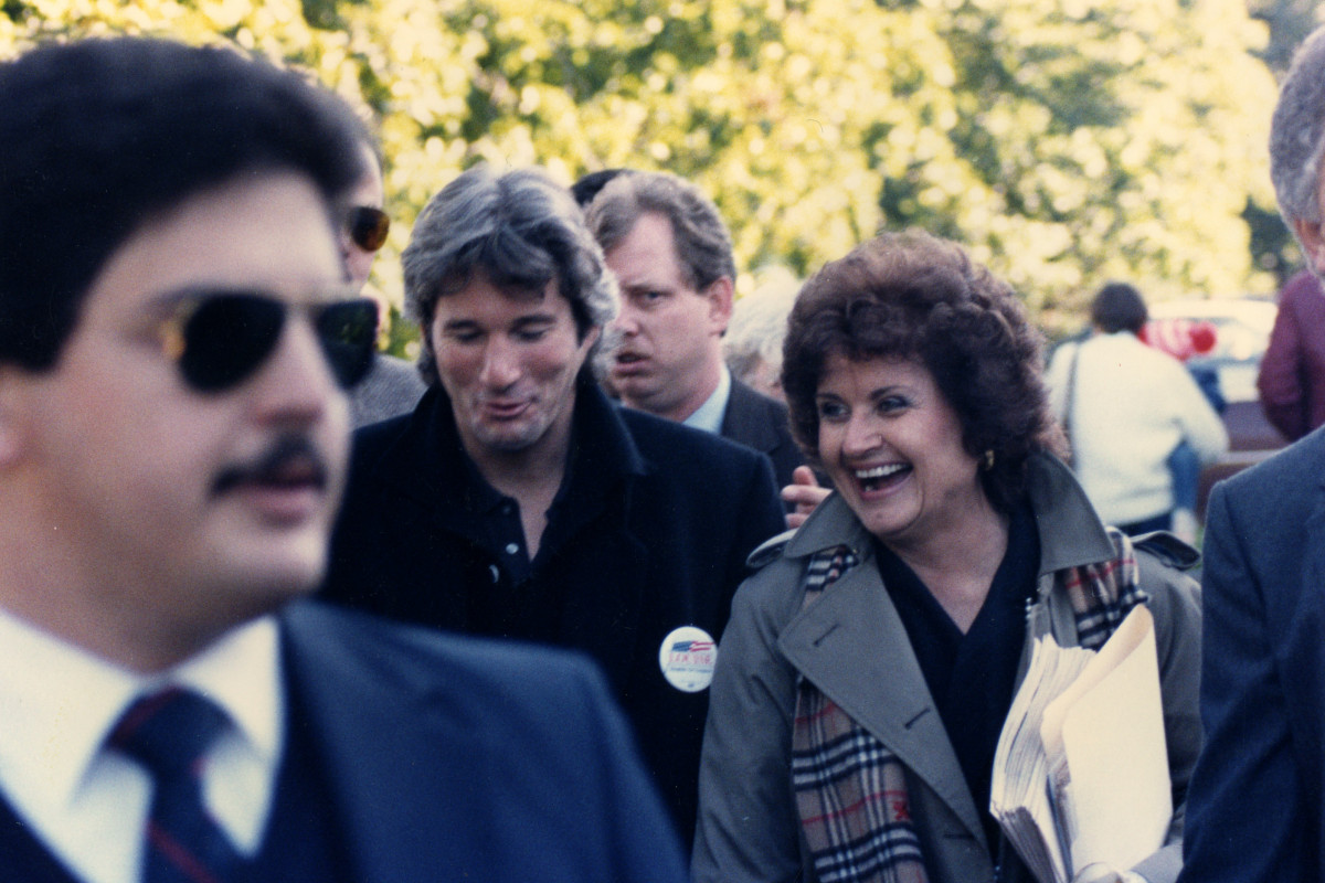 Congresswoman Louise Slaughter walking and laughing with Richard Gere