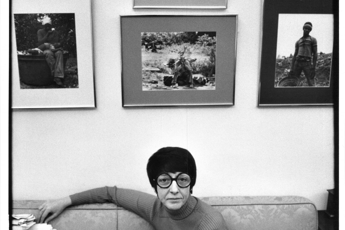 Midge Costanza sits on a couch