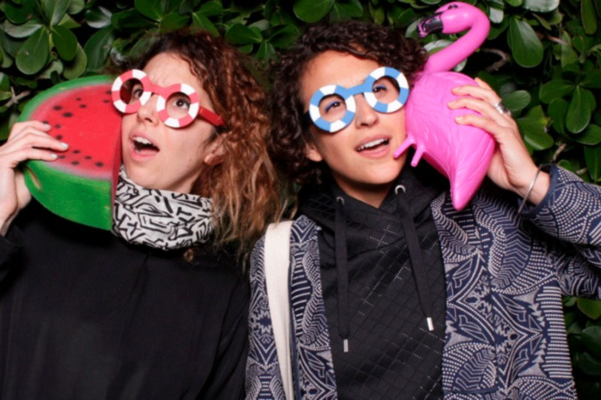 Speakers Ece Tankal and Carmen Aguilar y Wedge holding props and wearing funny glasses.