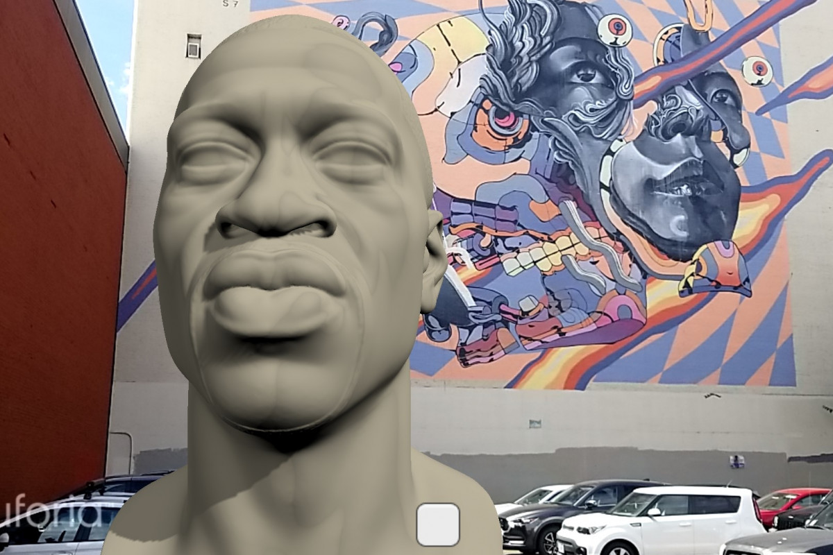 A virtual bust of George Floyd in front of a colorful mural in the Portland, Oregon