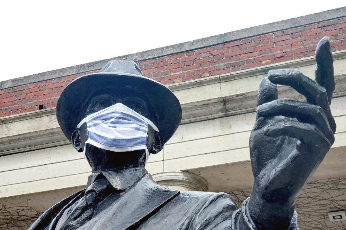 George Eastman statue wearing a COVID-19 mask