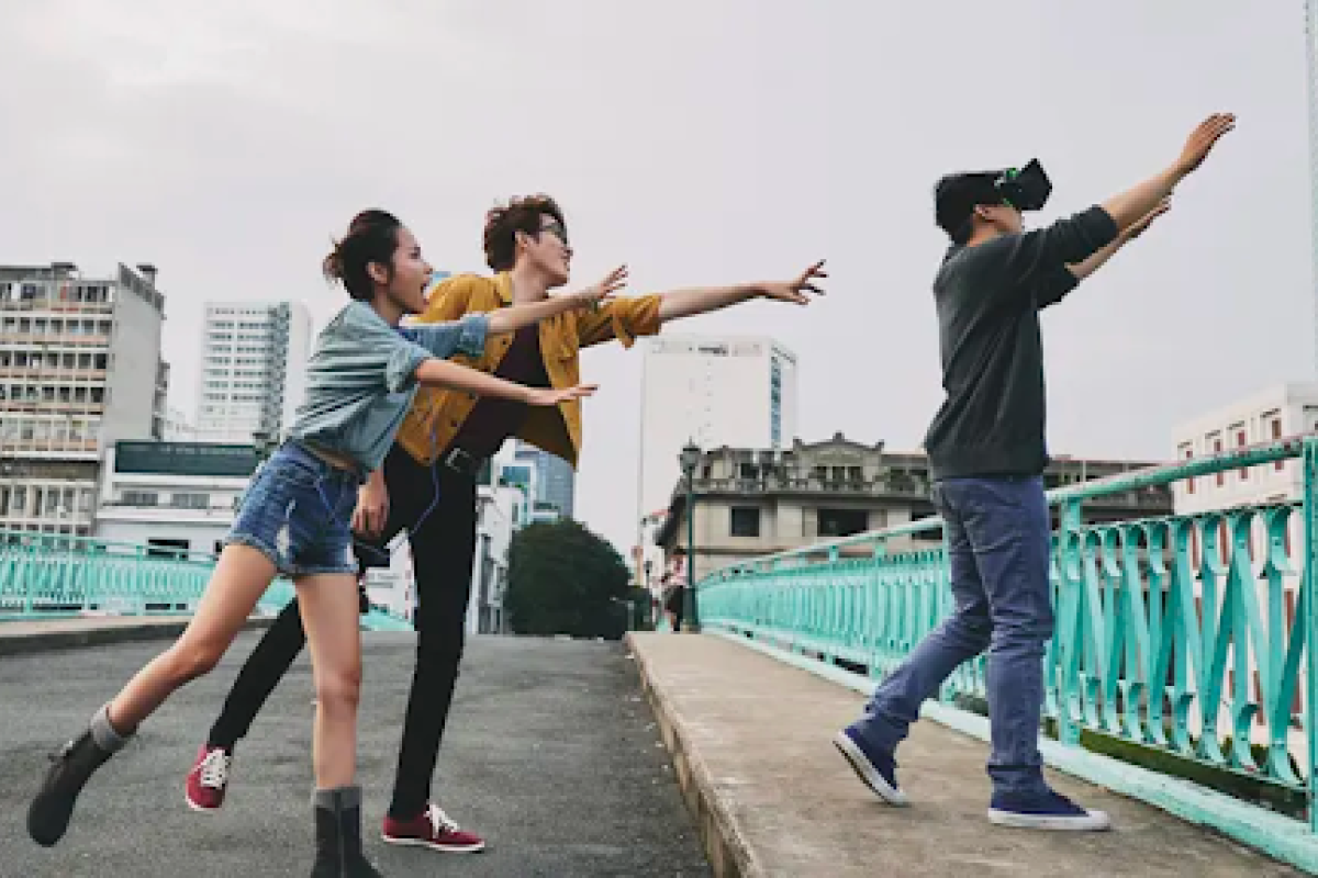 Person wearing a VR headset wanders near a bridge and two people dramatically try to stop the VR user from going off the side. 