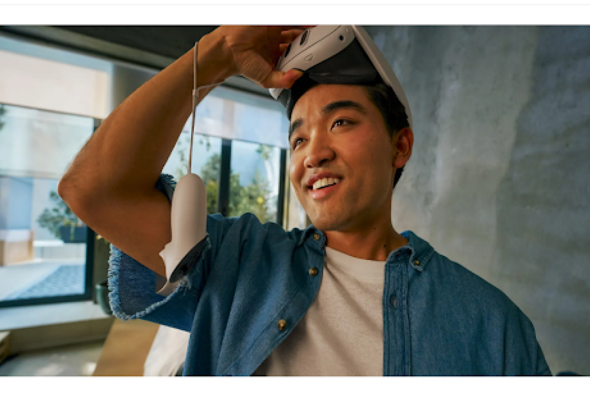 Person holding a virtual reality headset to their forehead looking amazed. 