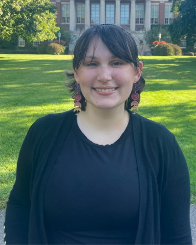 a portrait of Natasha Vacca in front of the Rush Rhees Library