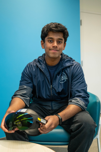 the author holding a virtual reality headset.