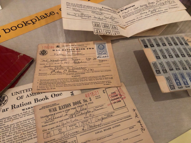 image of exhibit case containing World War II ration books and ration stamps
