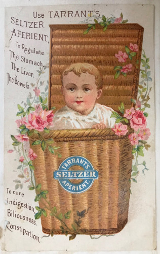 Trade card of baby in basket of flowers