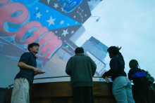 student participants talking with the dome in the background