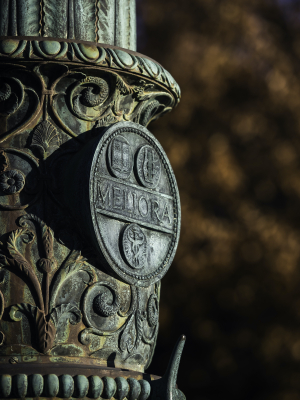 Ornate flagpole plaque at University of Rochester