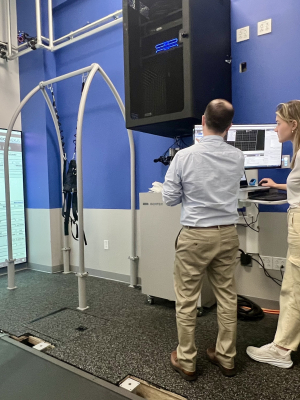 Mila and URMC motion Labs manager Josh discussing the project in front of lab equipment.